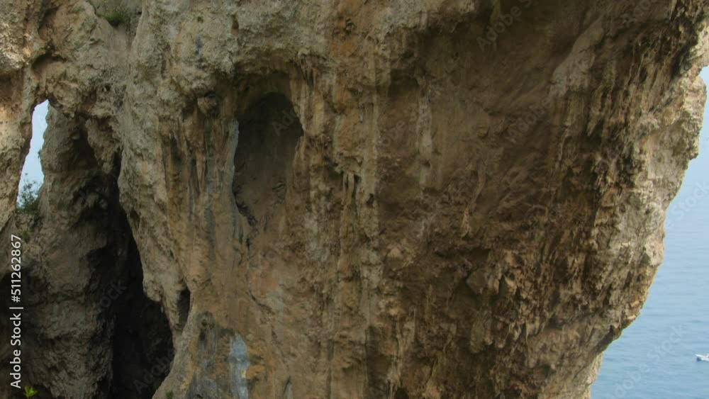 Close up shot of Arco Naturale, natural arch rock formation in Capri, Campania, Italy, Europe at daytime. Close up shot of Arco Naturale, natural arch rock formation in Capri, Campania, Italy, Europe at daytime.