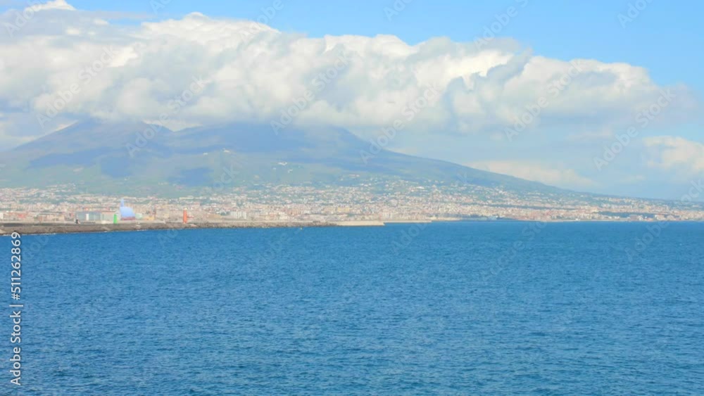 Shot of Naples skyline, port and Vesuvius volcano view in Naples, Italy on a sunny day. Shot of Naples skyline, port and Vesuvius volcano view in Naples, Italy on a sunny day.