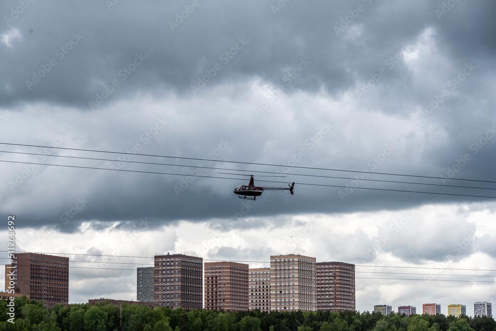 low-flying helicopter against the background of houses and the river low-flying helicopter against the background of houses and the river