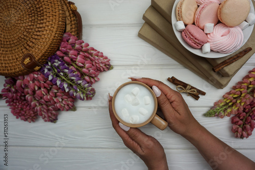 In the hands of a woman, freshly brewed cappuccino coffee photo