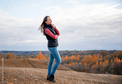 young woman in the autumn park in mountains