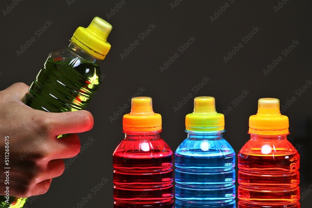 Hand holding a sports drinks, also known as electrolyte drinks, are