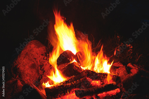 Closeup shot of outdoors campfire brightly burning at night.