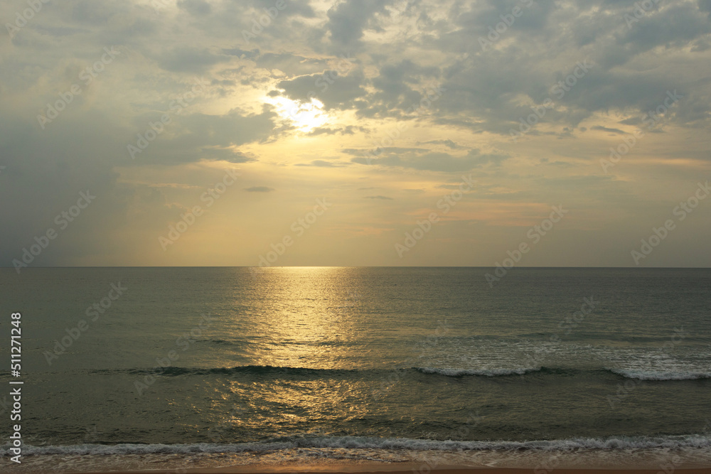 Sunset on the beach. Scenic seascape with clouds, waves and sun. Sunset on the beach. Scenic seascape with clouds, waves and sun.