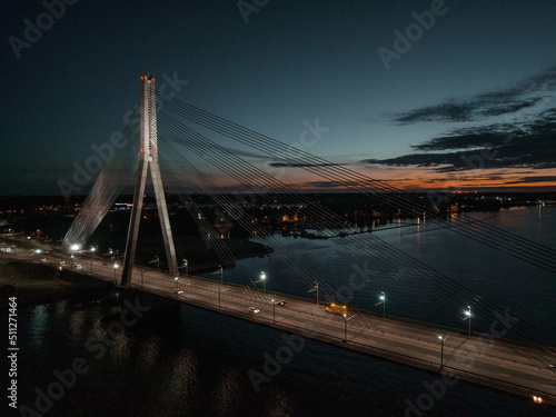 Aerial panoramic view of the Riga bridge across river Daugava at night. Cable-stayed bridge in Riga, Latvia at night.