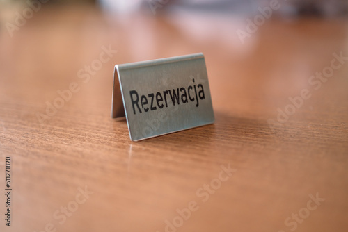 Iron reserved sign with capital letters on dining table in restaurant.