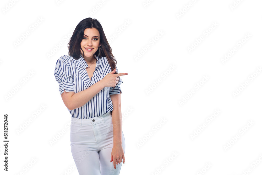 Beautiful smiling happy brunnet сaucasian young girl in white pants and striped shirt pointing right with her finger isolated on white background Beautiful smiling happy brunnet сaucasian young girl in white pants and striped shirt pointing right with her finger isolated on white background