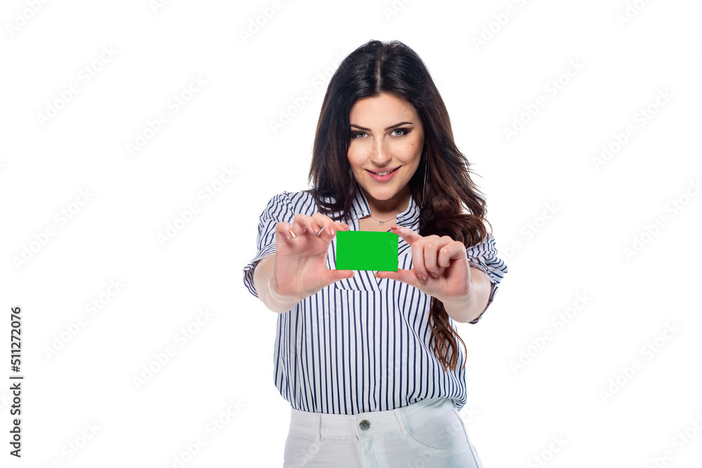 Beautiful brunnet сaucasian young girl in white pants and striped shirt holding bank or business card (saved with path) isolated on white background Beautiful brunnet сaucasian young girl in white pants and striped shirt holding bank or business card (saved with path) isolated on white background