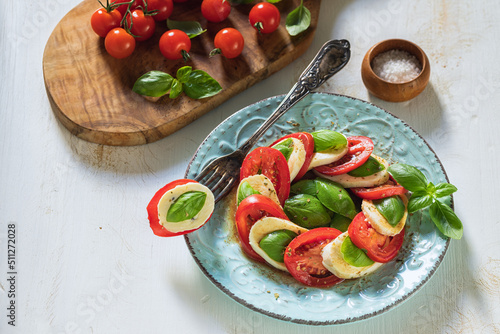 Fresh Italian Caprese Salad on Wooden Background