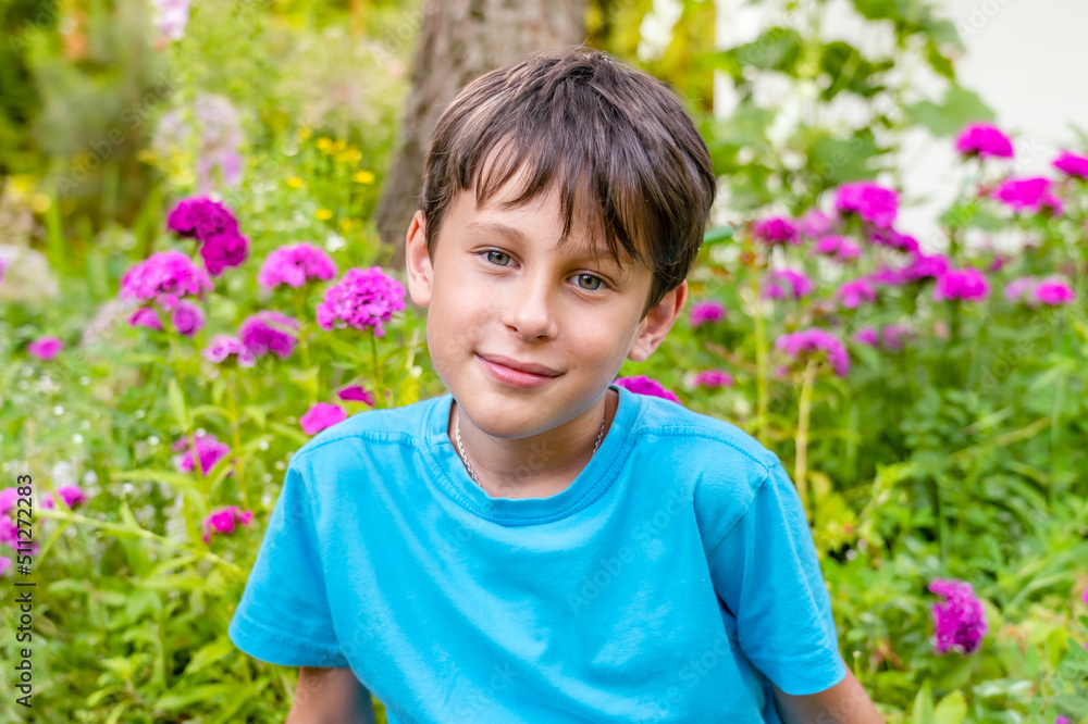 Head and shoulders of boy with flowers in his hands with a slight smile. Greeting card layout. Portrait of a boy 8 years old, white, caucasian Head and shoulders of boy with flowers in his hands with a slight smile. Greeting card layout. Portrait of a boy 8 years old, white, caucasian