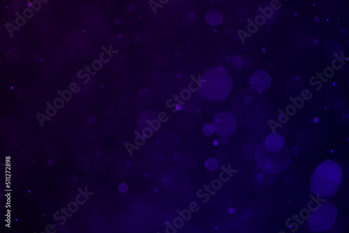 Dark purple bokeh glitter background.