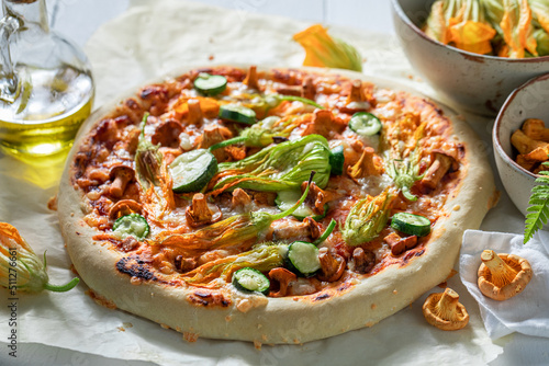 Hot pizza with chanterelles, zucchini flower and mozzarella