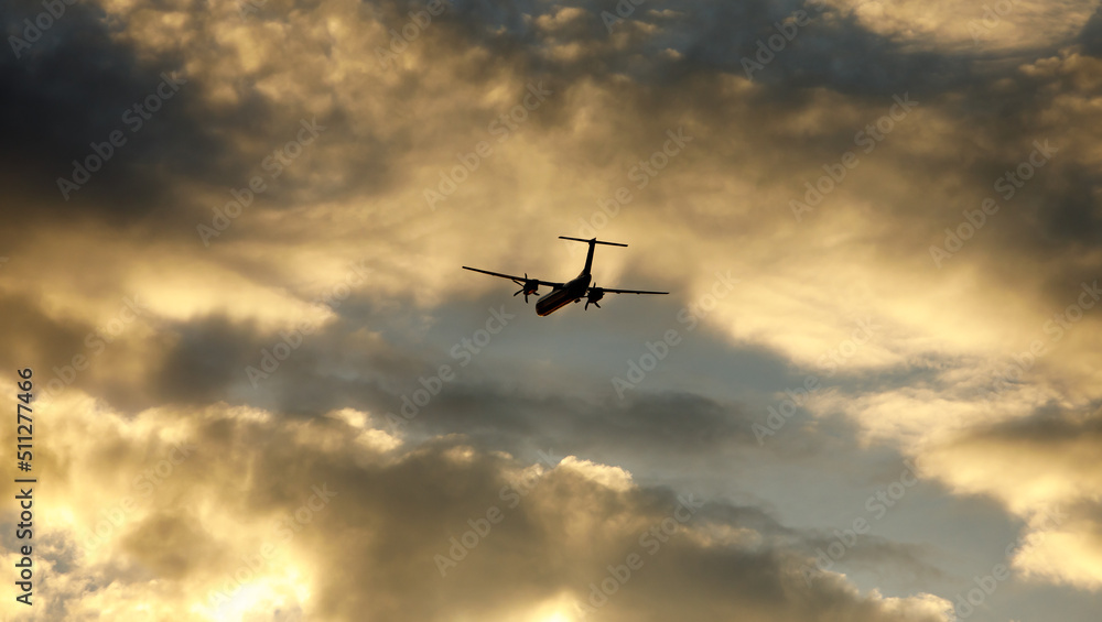 Silhouette of an airplane flying at sunset clouds. Silhouette of an airplane flying at sunset clouds.