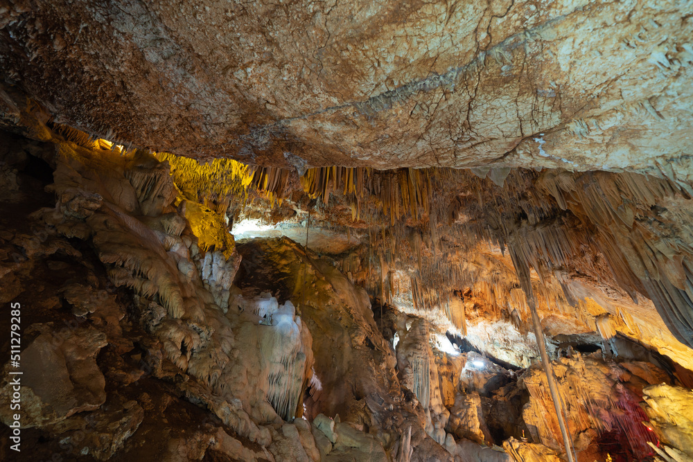 Natural stalactite and stalagmite rock stone cliff hang from cave ceiling in cave. Environmental explore. Landscape background. Erosion