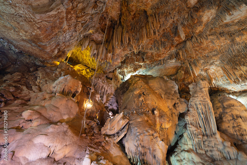Natural stalactite and stalagmite rock stone cliff hang from cave ceiling in cave. Environmental explore. Landscape background. Erosion