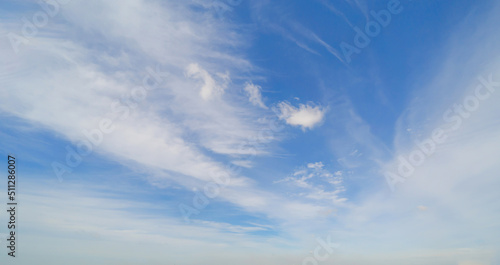 Clear blue sky with white fluffy clouds. Nature background.