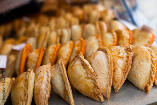 freshly baked empanadas with different fillings for sale