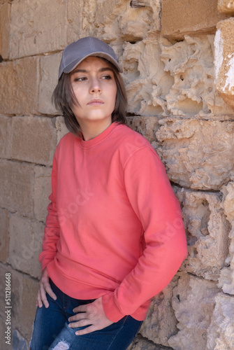 Teenager girl wearing pink long sleeve shirt and baseball cap outdoor, mockup