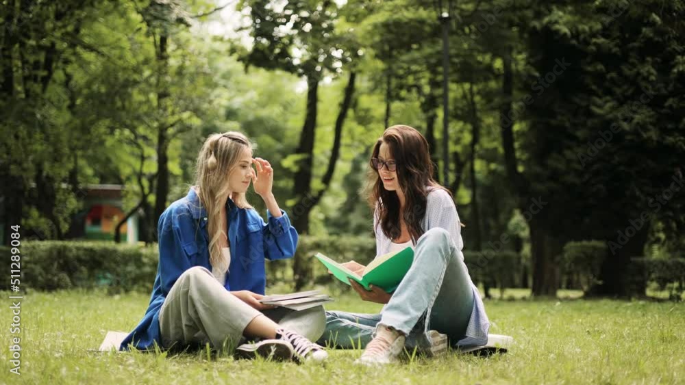 Group of college students study outside together. Portrait of young friends preparing for exams at campus park. Group of college students study outside together. Portrait of young friends preparing for exams at campus park.