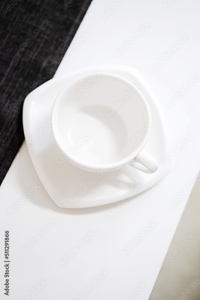 Empty white tea cup and saucer on the table. Porcelain dishes, selective focus. Empty white tea cup and saucer on the table. Porcelain dishes, selective focus.