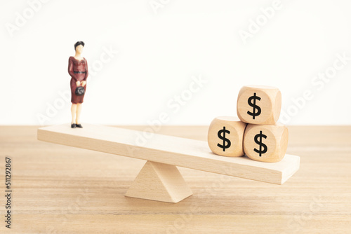 Life and Work or money balance concept. Businesswoman figurine and dollar symbol on wooden blocks on wooden seesaw