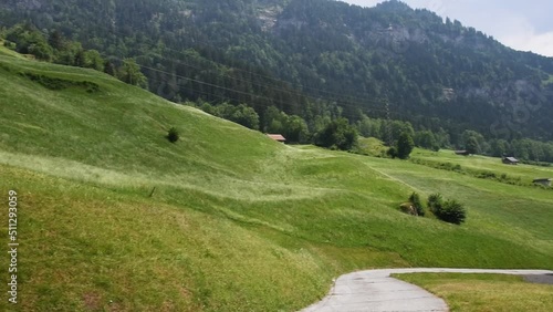 Landscape view of the roofs of traditional swiss houses, mountain Alps, green meadows, lawn. Incredibly bewitching and calm place.