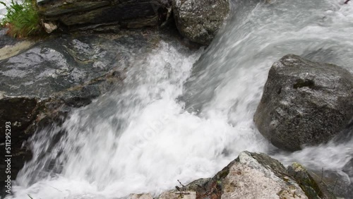 Mountain river flowing through the green forest. Swiss Alps, crystal clear glacial water, mountain spring.