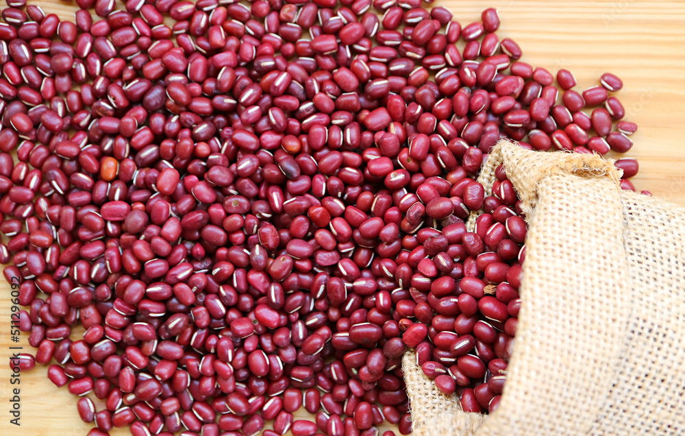 Top View of Dried Adzuki Red Beans Scattered from Burlap Bag on to Wooden Table Top View of Dried Adzuki Red Beans Scattered from Burlap Bag on to Wooden Table