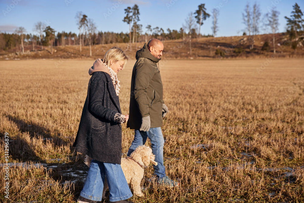 Couple walking with dog Couple walking with dog