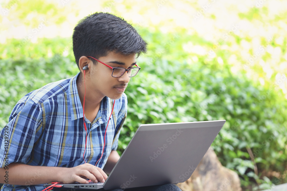 Portrait of Indian boy using laptop while attending the online classes
Portrait of Indian boy using laptop while attending the online classes