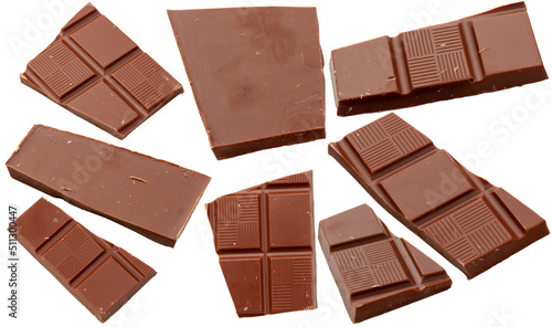 Milk chocolate. Flying pieces of milk chocolate, isolated on white background.