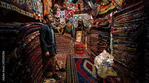 a guy in a room with carpets in turkey
