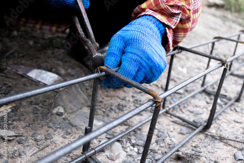 Workers are tying steel to make steel structures for building houses.