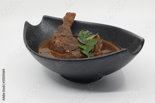 indian pepper fish curry on black bowl 