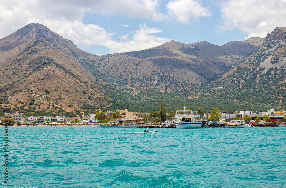 Village of Elounda also known as Elounta or Elouda on island of Crete in Greece, Europe. Seen from sea. 2022 summer.