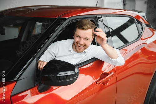 Man buying a car at a showroom