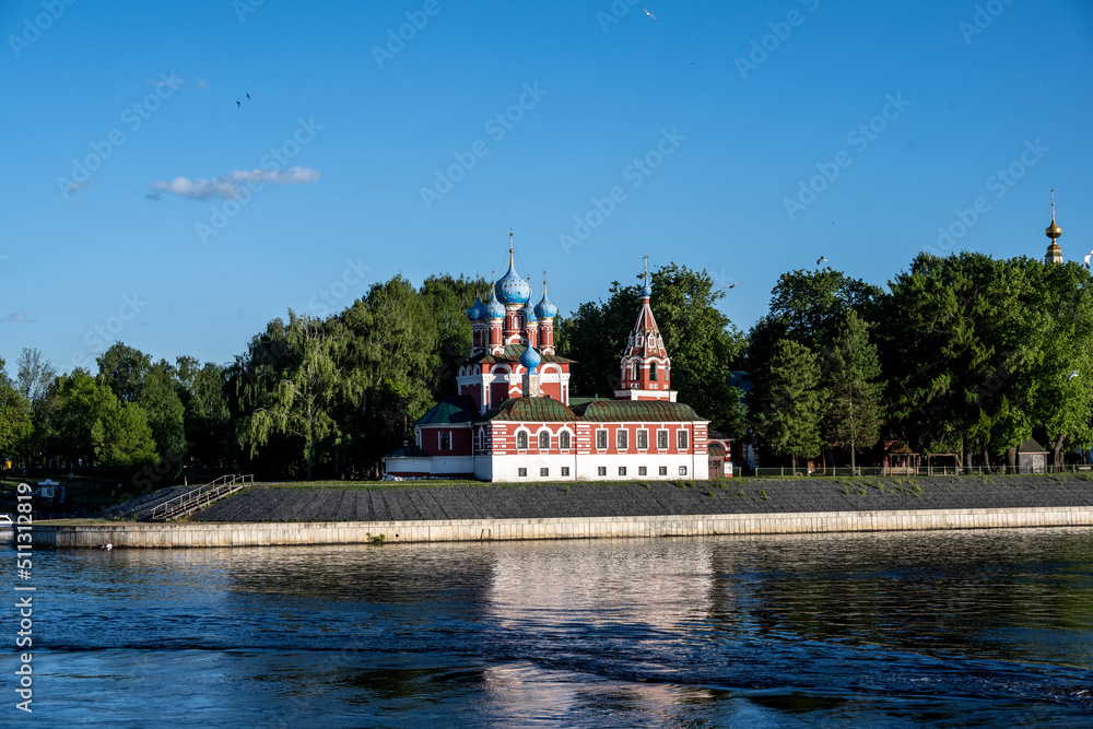 Fototapeta premium summer landscape with ancient churches against the backdrop of a forest and a river on a sunny day
