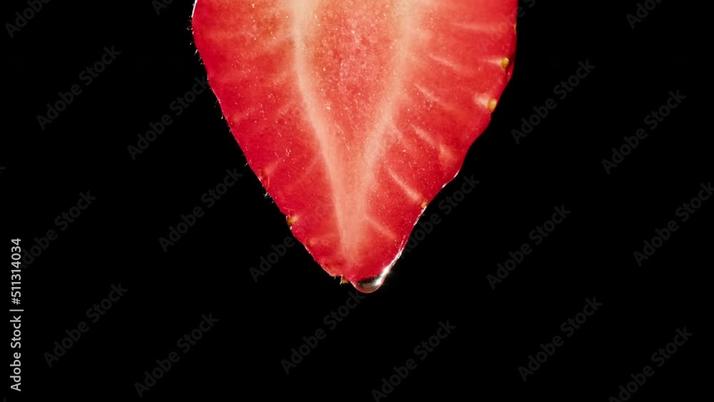 Red strawberry half isolated on black background, juicy ripe berry close-up, sweet fresh fruits. Red strawberry half isolated on black background, juicy ripe berry close-up, sweet fresh fruits.
