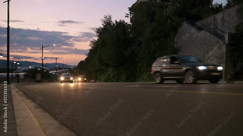 Road traffic on a sunset background. Road with cars on a background of the sky with the sunset. Tbilisi Georgia. Road traffic on a sunset background. Road with cars on a background of the sky with the sunset. Tbilisi Georgia.