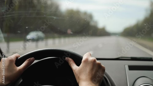 woman is driving an SUV on the highway in the summer