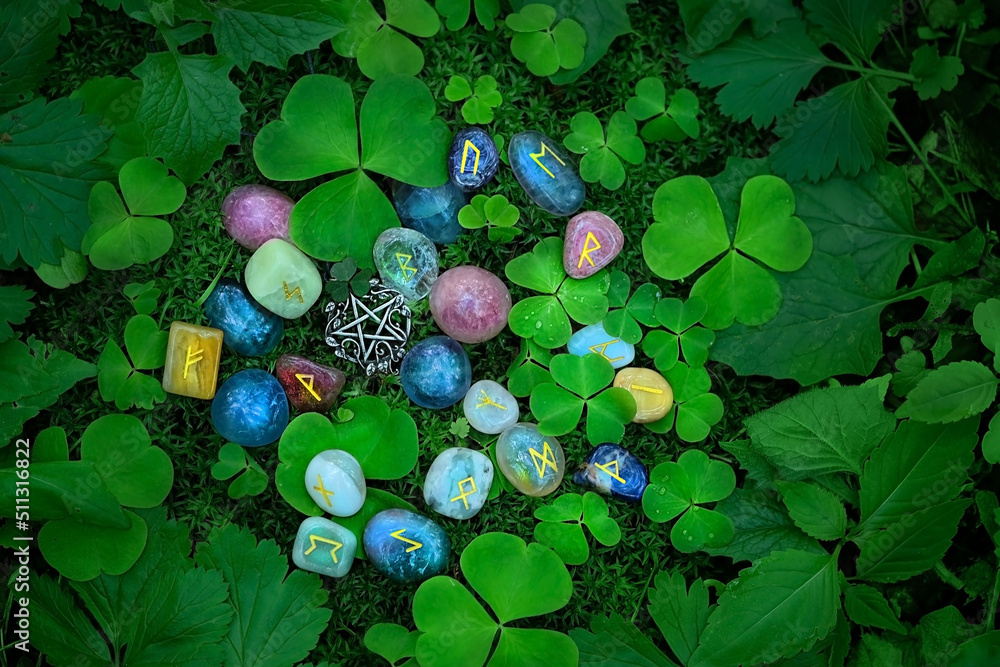 Rune stones with symbols and clover leaves on abstract dark natural ...