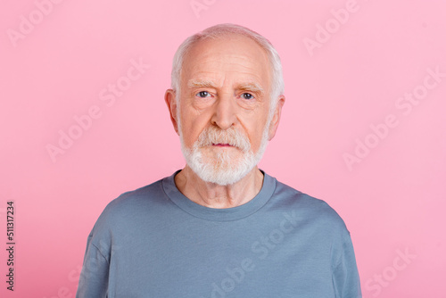Photo of serious confident charming retired man grey sweater isolated pink color background photo