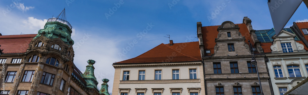Low angle view of buildings and sky in Wroclaw, banner