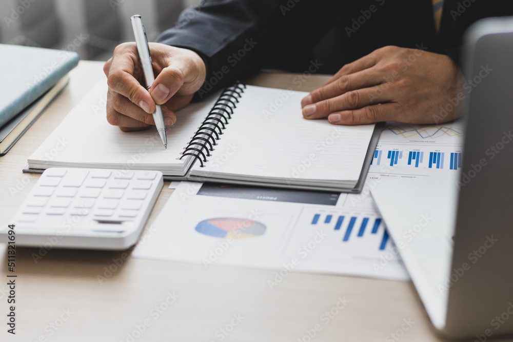 Businessman or accountant analysis financial report, computer with graph chart. Finance and Accounting concepts. Businessman or accountant analysis financial report, computer with graph chart. Finance and Accounting concepts.