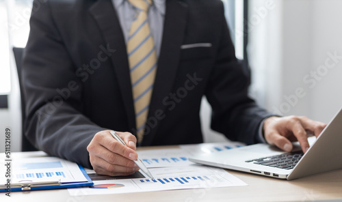 Businessman or accountant financial expert analyze business report graph and finance chart in office. Concept of finance economy, banking business and stock market research.