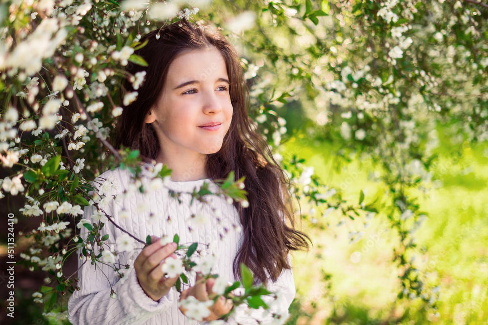 beautiful girl in a pink jumper holds a branch of a blossoming white apple tree beautiful girl in a pink jumper holds a branch of a blossoming white apple tree