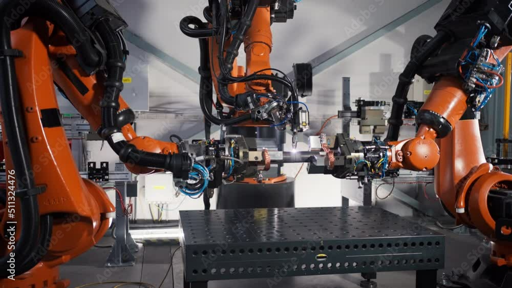 Robotic arm working in modern automobile factory. Robotic arm working in modern automobile factory.