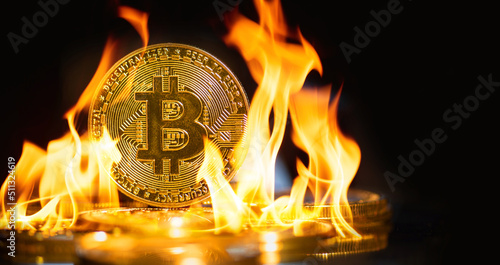 Burn the golden bitcoin coin sits on a stack of cryptocurrencies