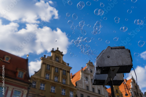 Low angle view of soap bubbles appliance on blurred urban street in Wroclaw
