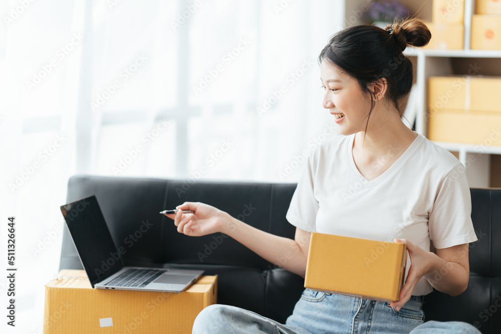 Portrait young attractive asian female owner startup business work happy with box at home prepare parcel delivery in sme supply chain, start up small business concept. Portrait young attractive asian female owner startup business work happy with box at home prepare parcel delivery in sme supply chain, start up small business concept.